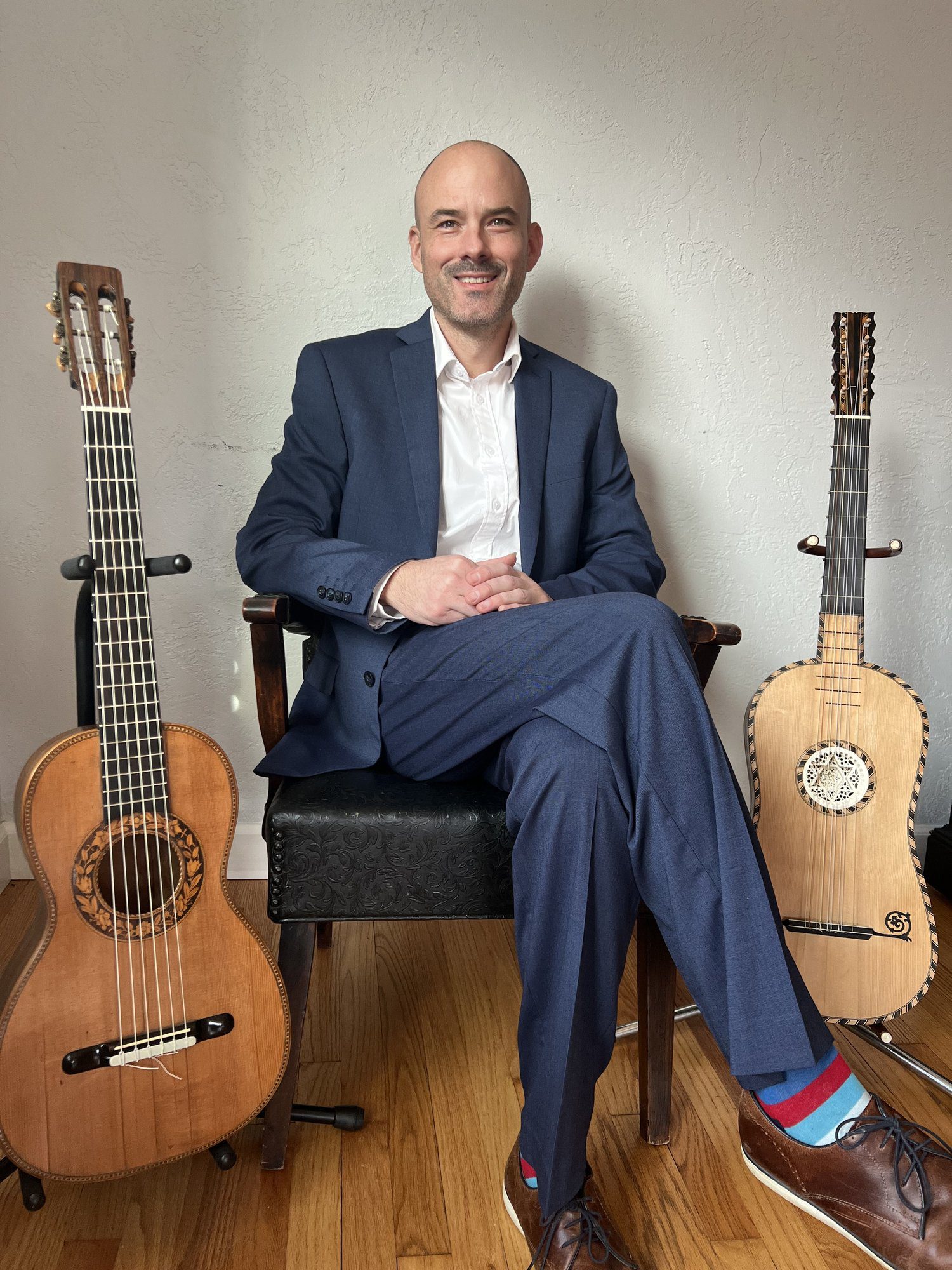 Patrick Rafferty sits amid his guitars.